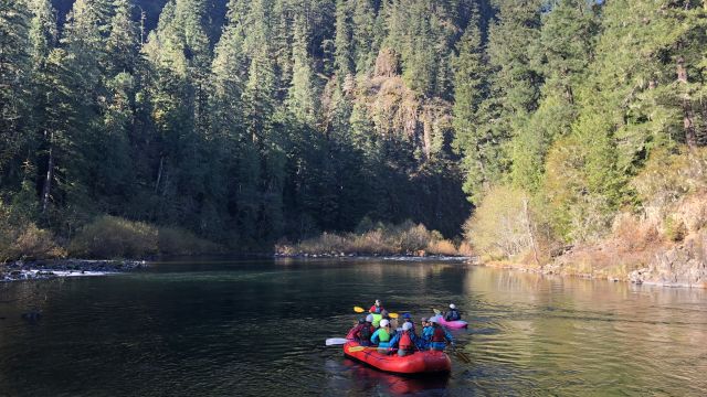 A group of students participate in the Outdoor Pursuits program by rafting down an Oregon river.