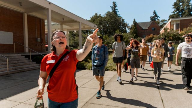 An admissions staffer leads future students on a tour of the Pacific University Forest Grove Campus